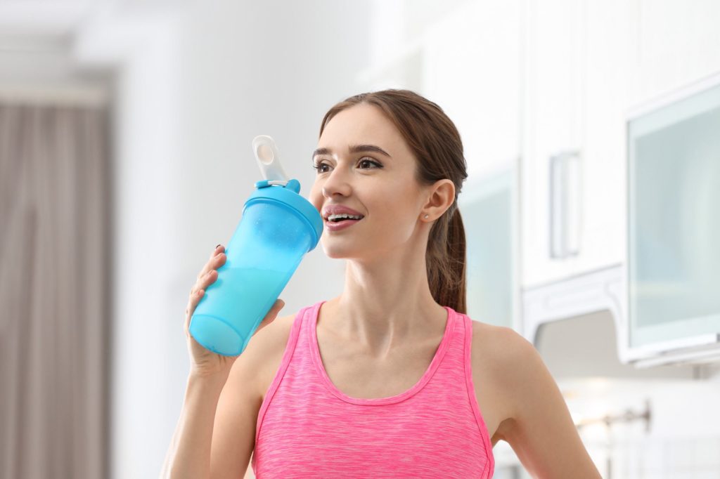 Girl drinking pre workout